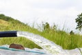 Close up of water gushing out of the pipe. Water is flowing from water pump through large pipe Royalty Free Stock Photo