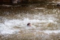 Close-up of water huge splashing in pond from people falling into water