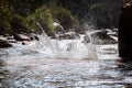 Close-up of water huge splashing in pond from people falling into water