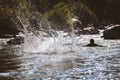 Close-up of water huge splashing in pond from people falling into water