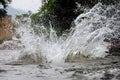 Close-up of water huge splashing in pond from people falling into water