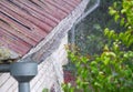 Close up of water overflowing from old gutter during a heavy rainfall Royalty Free Stock Photo