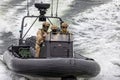 Close up of Water Police in camoflauge on high speed RIB on surveillance patrol on the Swan River, near Perth, Australia