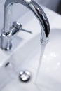 Saving water: Close up of spigot with clear, flowing water Royalty Free Stock Photo