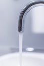 Saving water: Close up of spigot with clear, flowing water Royalty Free Stock Photo