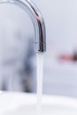 Saving water: Close up of spigot with clear, flowing water Royalty Free Stock Photo