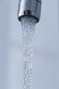 Saving water: Close up of spigot with clear, flowing water Royalty Free Stock Photo