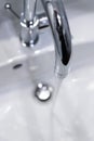 Saving water: Close up of spigot with clear, flowing water Royalty Free Stock Photo