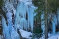 CLOSE UP: Waterfall freezing in the winter cold creates beautiful icicles. Royalty Free Stock Photo