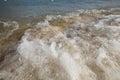 Close up wave on a sand beach, sea foam, splash of the sea Royalty Free Stock Photo