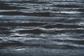 Close up of waves in dark blue silver shining ocean during storm in Spain Royalty Free Stock Photo