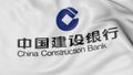 Close up of waving flag with China Construction Bank logo, 3D rendering