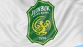 Close-up of waving flag with Jeonbuk Hyundai Motors FC football club logo, seamless loop, blue background. Editorial