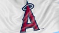 Close-up of waving flag with Los Angeles Angels of Anaheim MLB baseball team logo, seamless loop, blue background