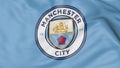 Close-up of waving flag with Manchester City F.C. football club logo