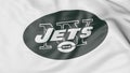 Close-up of waving flag with New York Jets NFL American football team logo, 3D rendering