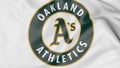 Close-up of waving flag with Oakland Athletics MLB baseball team logo, 3D rendering