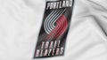 Close-up of waving flag with Portland Trail Blazers NBA basketball team logo, 3D rendering