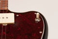 Close up of 3 way pickup switch on black electric guitar, studio shoot. Red tortoise shell pickguard, alder body, two single coil Royalty Free Stock Photo