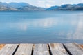 Aged gray picnic table-top with view of lake and mountains Royalty Free Stock Photo