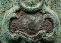Close-up of a weathered, patinated bronze surface with intricate embossed patterns. Royalty Free Stock Photo
