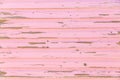 Close up of weathered pink paintwork on wooden boards of beach shack with copy space Royalty Free Stock Photo