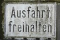German `Keep clear` sign screwed on a garage door