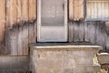 Close up of Weathered Wood Siding Beginning to Rot Around Front Step of Cottage or House Royalty Free Stock Photo