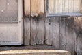 Close up of Weathered Wood Siding Beginning to Rot Around Front Step of Cottage or House Royalty Free Stock Photo