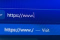 Close up of a web browser search bar on a blue pixelated screen showing a secure https prefix with a flashing cursor Royalty Free Stock Photo