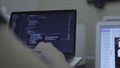 Close-up of web developer's hands programming Javascript, coding HTML on laptop. Stock. View from back Royalty Free Stock Photo