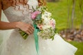 Close up of wedding bouquet of flowers holded by happy young bride with curly hair Royalty Free Stock Photo