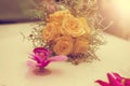 Close-up of wedding bouquet made of yellow roses on white limousine hood. Vintage tone. Royalty Free Stock Photo