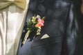 Close up of wedding boutonniere flower on groom`s suit. Colorful posy on lapel of jacket. Blue / white dress combination Royalty Free Stock Photo