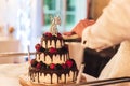 Close up of wedding cake cutting. Wedding couple holding knife together and slicing wedding cake with berries. Wedding Royalty Free Stock Photo