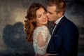 Close-up wedding portrait. The groom is tenderly kissing the charming happy ginger hair bride in the cheek. Royalty Free Stock Photo