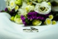 Close-up of wedding rings on the background of a wedding bouquet. Royalty Free Stock Photo