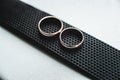 Close up of wedding rings on a black leather belt Royalty Free Stock Photo