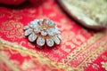 Close up of wedding rings on a exotic jewelry on a red minangkabau ethnic fabric