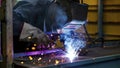 welder is welding in the workstation, welder at the workstation, welder doing hard work in garage Royalty Free Stock Photo