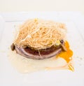 Close up of well cocked sandwich with meet, eggs, cheese with pasta on top Royalty Free Stock Photo