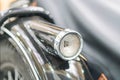 Close-up of a well-maintained vintage motorcycle, with emphasis on the headlight and engine components, captured from below and Royalty Free Stock Photo