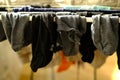 close-up of wet dark men\'s socks, laundry hanging and drying on wire room dryer