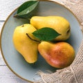 Close-up of wet yellow pears on blue plate Royalty Free Stock Photo