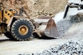 Industrial machinery working with rock breaker and crusher, dumper trucks