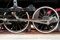 Close up wheels on steam powered locomotive.