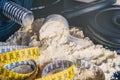 Close-up of Whey Protein Spoon Powder, with weights and tape measure