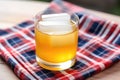 close up of a whiskey sour cocktail with a patterned napkin underneath Royalty Free Stock Photo