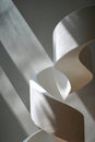 Abstract White Spiral Sculpture With Dramatic Sunlight Shadows On Textured Wall Royalty Free Stock Photo