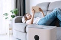 Close up of white air purifier on the floor in living room the background of young Asian woman relaxes. Concept of caring for